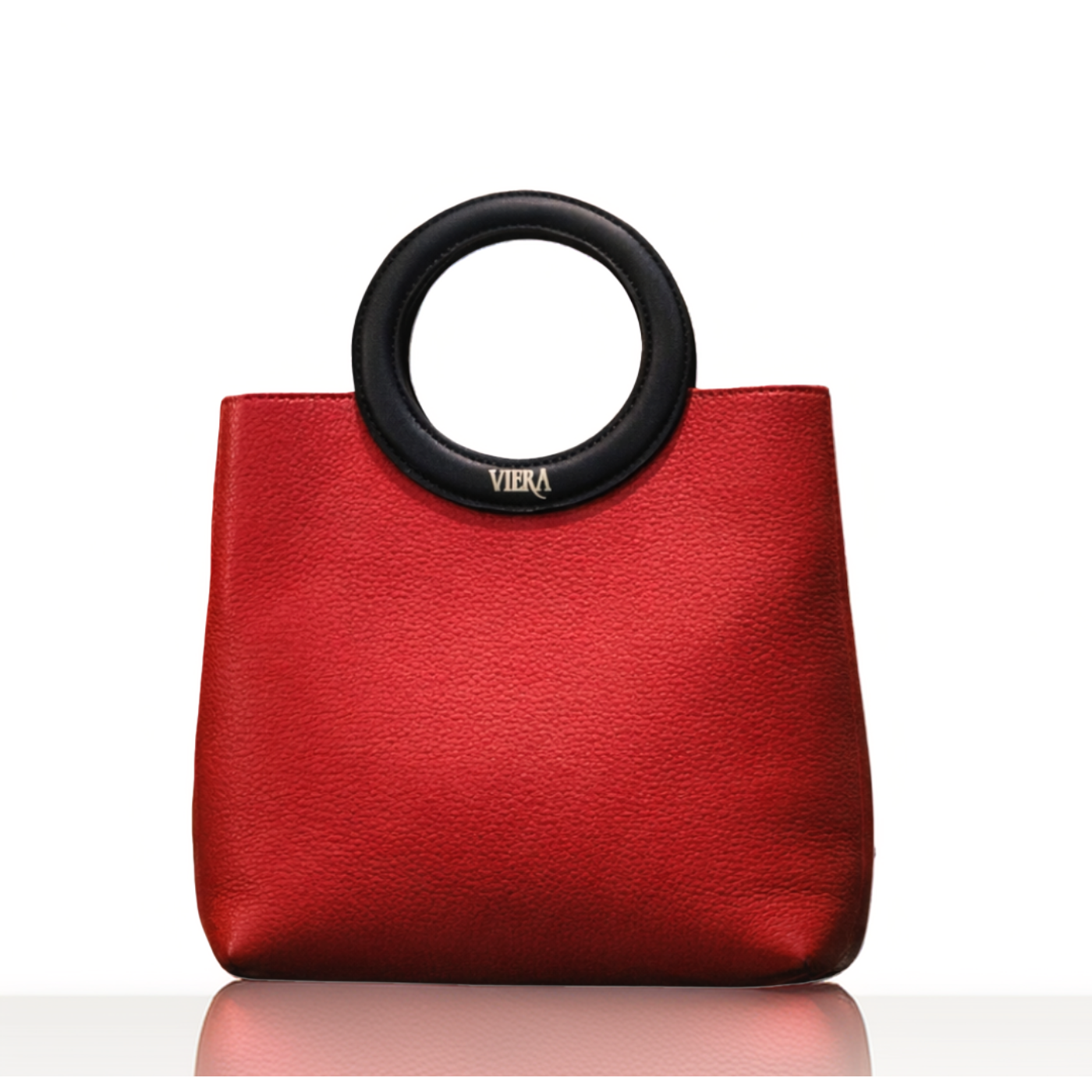 red tote handbag with distinctive round handle offers a comfortable grip and modern aesthetic